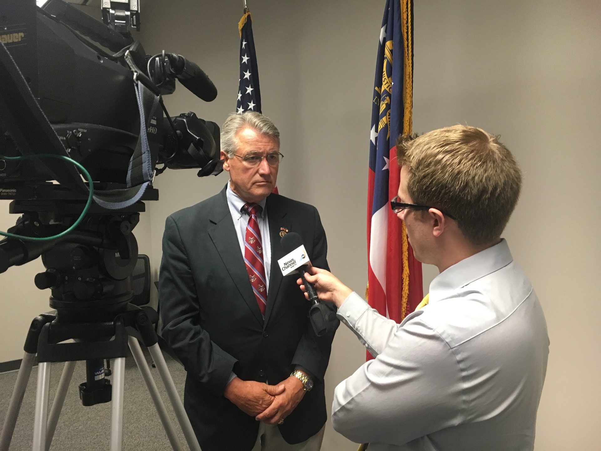 Mike Miller interviewing a public official on camera